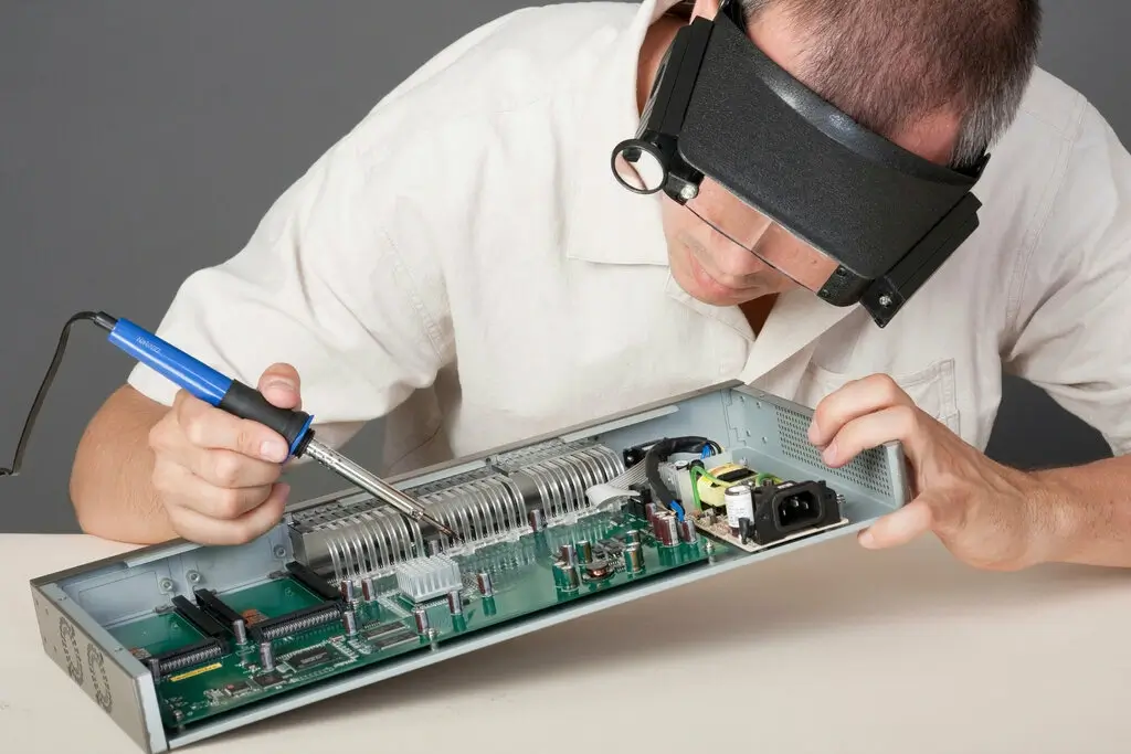 Technician soldering wires with precision