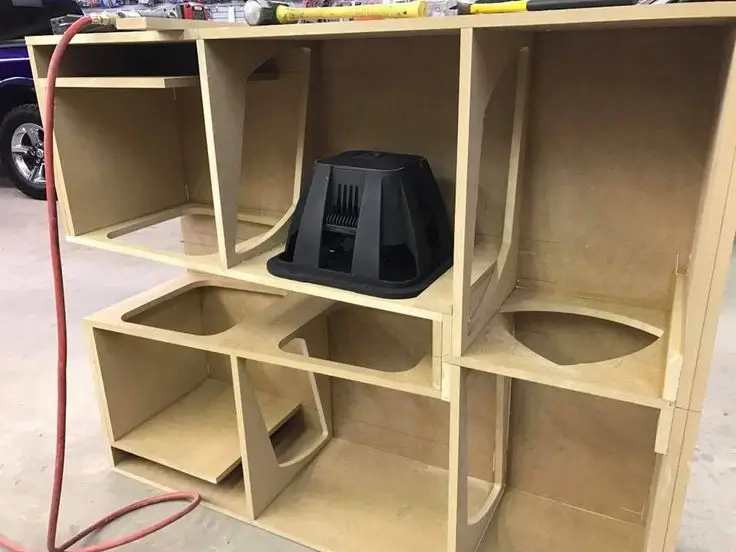 Custom fiberglass subwoofer enclosure being sanded