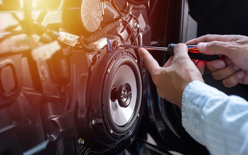 Technician installing sound deadening material