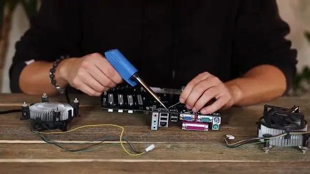 Technician carefully soldering a connection